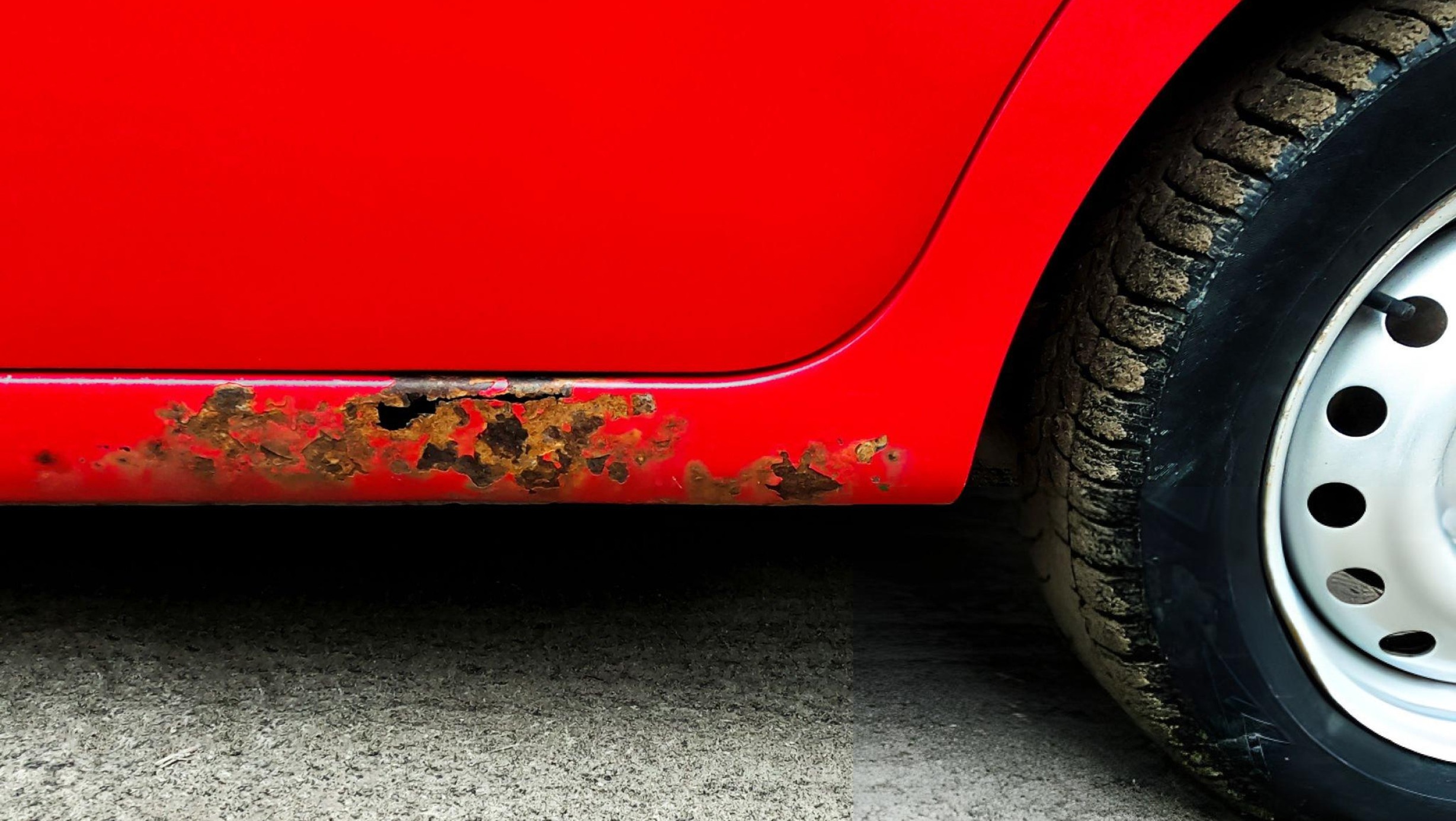 Hero image of a car panel with visible rust spot transitioning to a freshly repaired and painted surface, minimal tools in frame