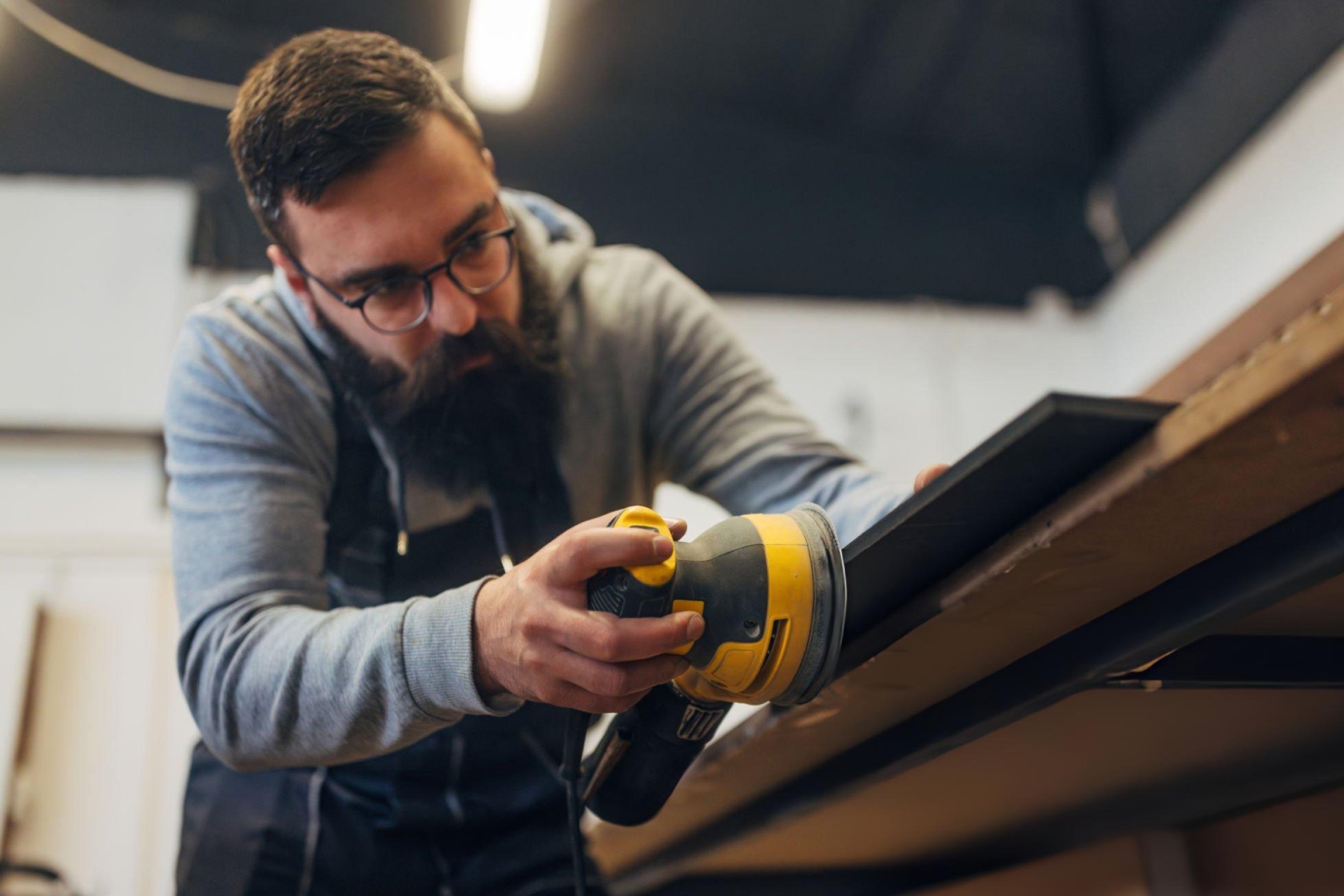 Top-rated random orbital, sheet and detail sanders for DIY enthusiasts in 2025 displayed on wooden surface for furniture refinishing projects