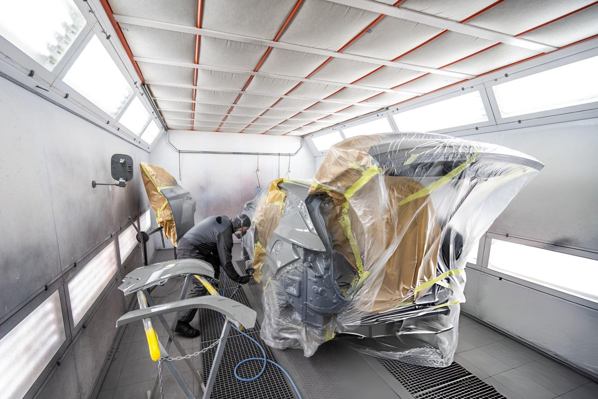 Automotive refinishing tools used to create a swirl free paint finish with a random orbital polisher on a car panel