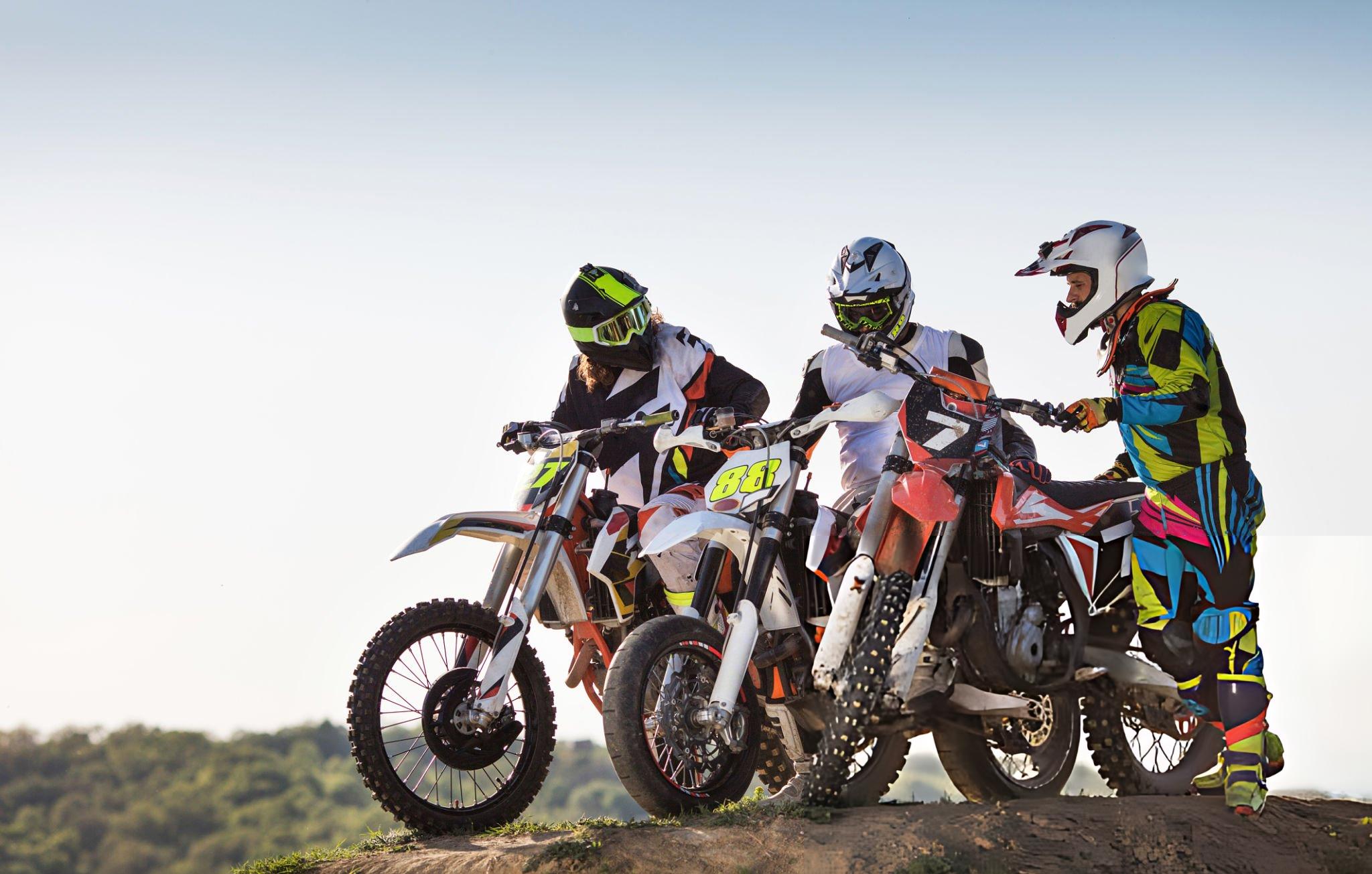 Private label vs wholesale dirt bikes in a factory showroom comparing branded models and generic wholesale units for B2B buyers